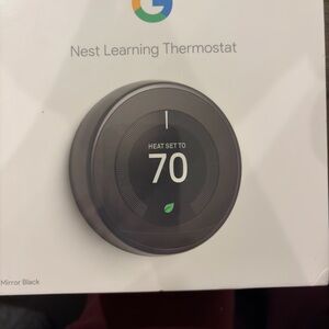 Nest Learning Thermostat in Mirror Black - New in box. Never been opened.